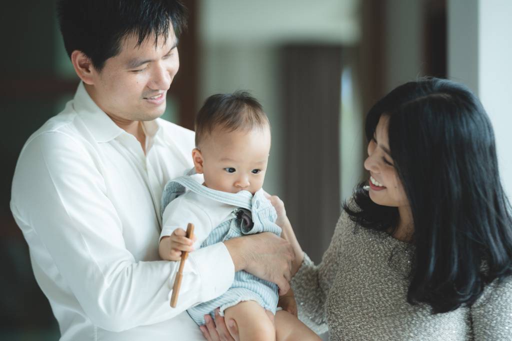 young Asian family are happy together at home by life insurance concept, child baby and mother